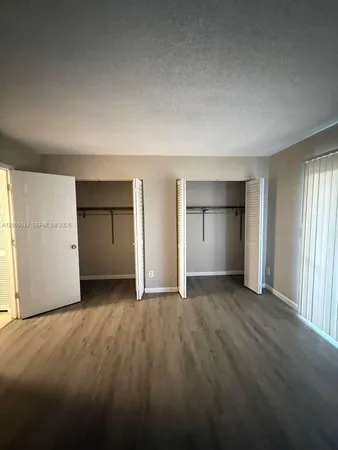an empty room with a kitchen and a sink