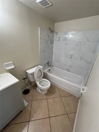 a bathroom with a toilet and a bathtub