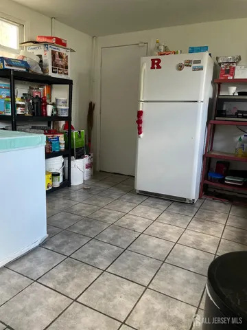 a white refrigerator freezer sitting inside of a kitchen