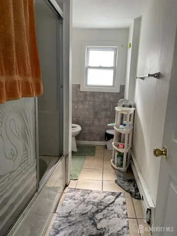 a bathroom with a toilet and a shower
