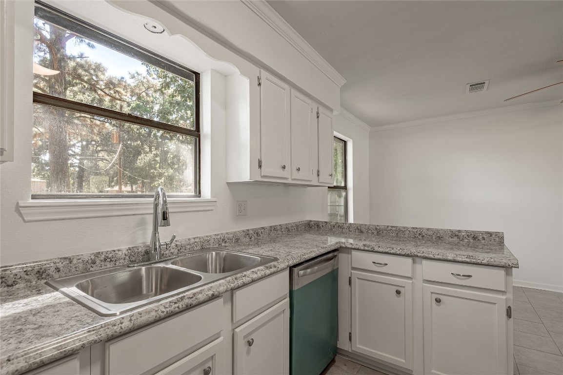 169 Sunset Drive Trinity, TX 75862 - Photo 12 of 36 a kitchen with granite countertop white cabinets and a sink
