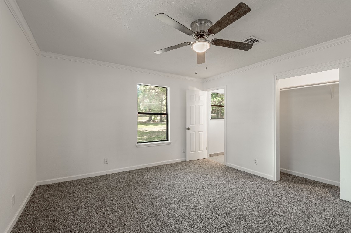 169 Sunset Drive Trinity, TX 75862 - Photo 15 of 36 an empty room with windows and fan