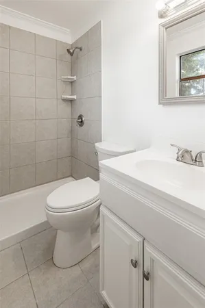 a bathroom with a toilet sink and shower