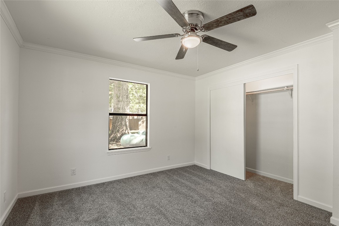 169 Sunset Drive Trinity, TX 75862 - Photo 20 of 36 an empty room with windows and fan