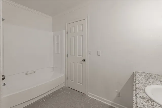 a bathroom with a granite countertop sink a toilet and bathtub