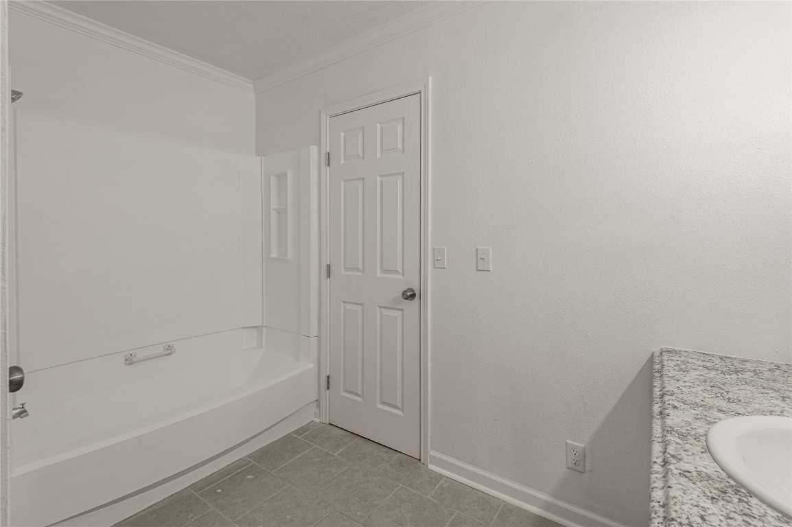 169 Sunset Drive Trinity, TX 75862 - Photo 24 of 36 a bathroom with a granite countertop sink a toilet and bathtub