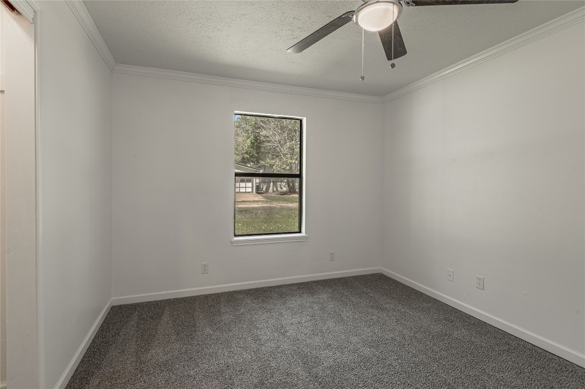 169 Sunset Drive Trinity, TX 75862 - Photo 25 of 36 an empty room with a window and ceiling fan