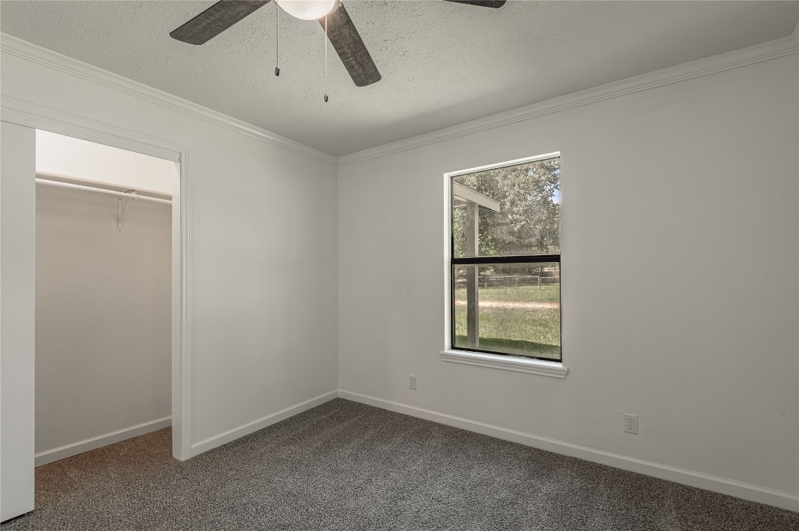 169 Sunset Drive Trinity, TX 75862 - Photo 26 of 36 an empty room with windows and closet