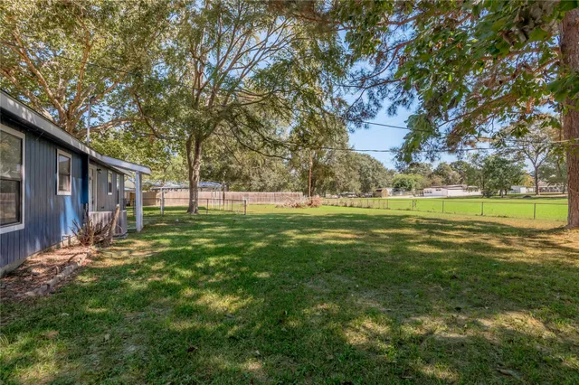 a backyard of a house with lots of green space
