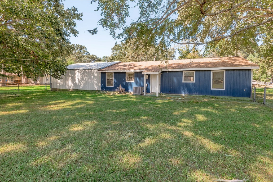 169 Sunset Drive Trinity, TX 75862 - Photo 32 of 36 a view of a house with a yard and a large tree