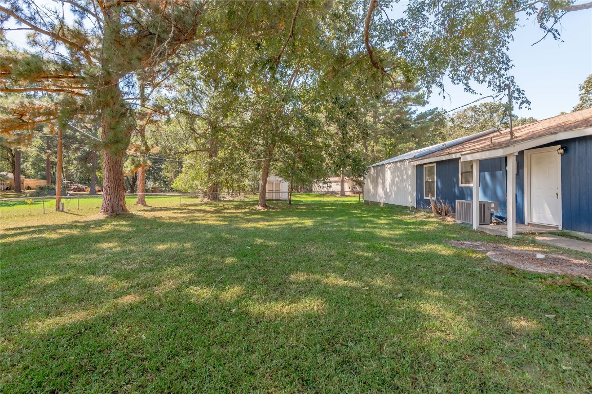 169 Sunset Drive Trinity, TX 75862 - Photo 33 of 36 a view of a house with a big yard and large trees