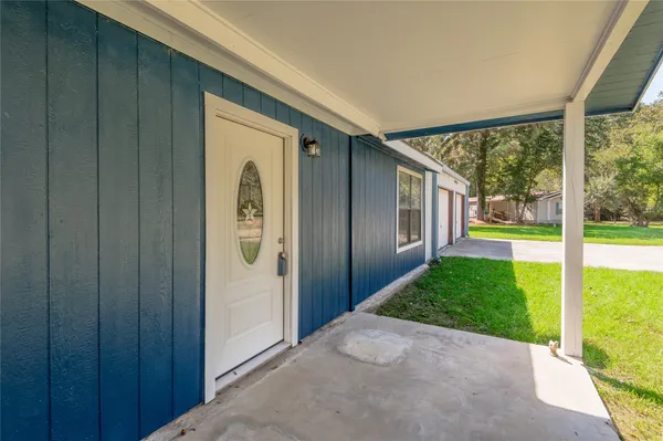 a view of a porch with wooden floor and entryway
