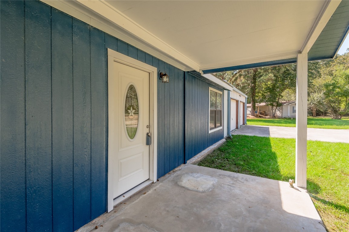 169 Sunset Drive Trinity, TX 75862 - Photo 4 of 36 a view of a porch with wooden floor and entryway