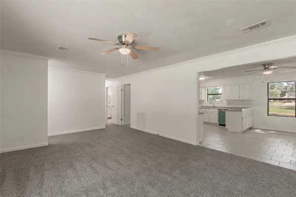 a view of a livingroom with a ceiling fan and window