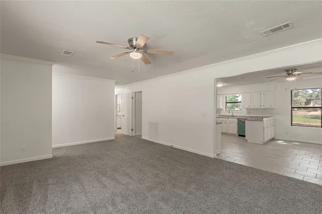 a view of a livingroom with a ceiling fan and window