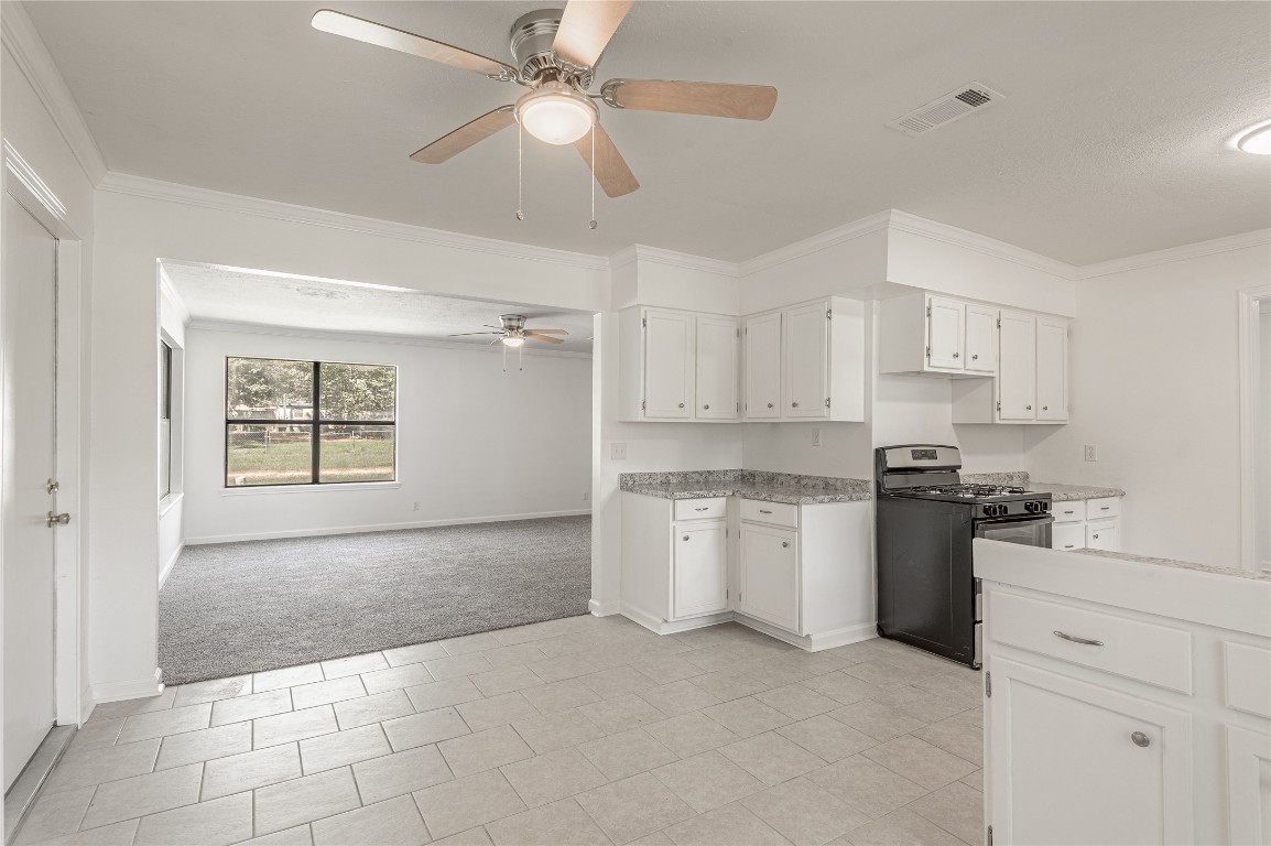 169 Sunset Drive Trinity, TX 75862 - Photo 9 of 36 a kitchen with a stove a sink and a refrigerator