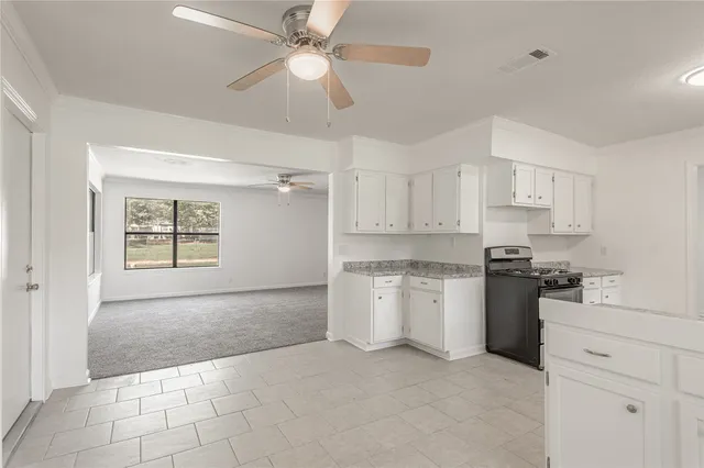 a kitchen with a stove a sink and a refrigerator
