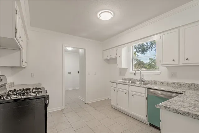 a kitchen with a sink stove and cabinets