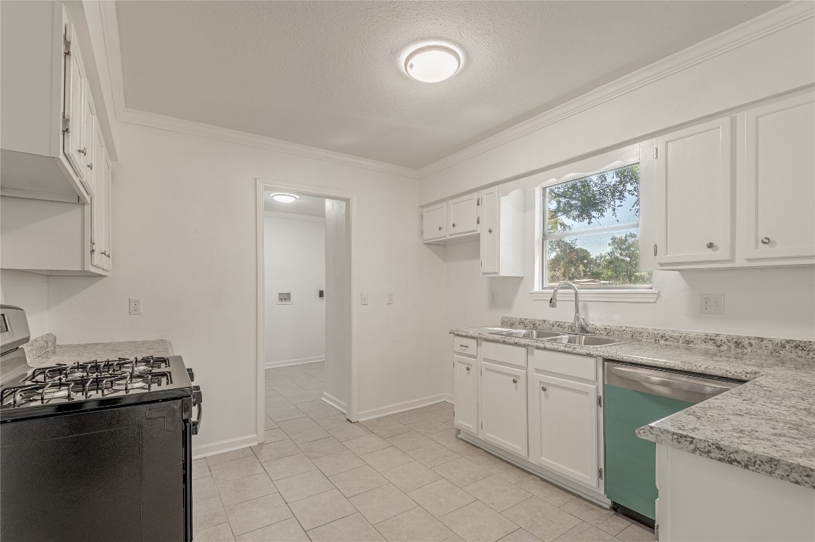 169 Sunset Drive Trinity, TX 75862 - Photo 10 of 36 a kitchen with a sink stove and cabinets