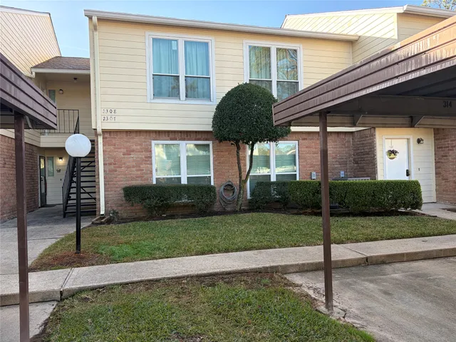 a view of a house with a yard and garage