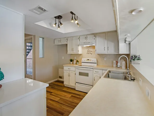 a kitchen with a sink appliances and cabinets