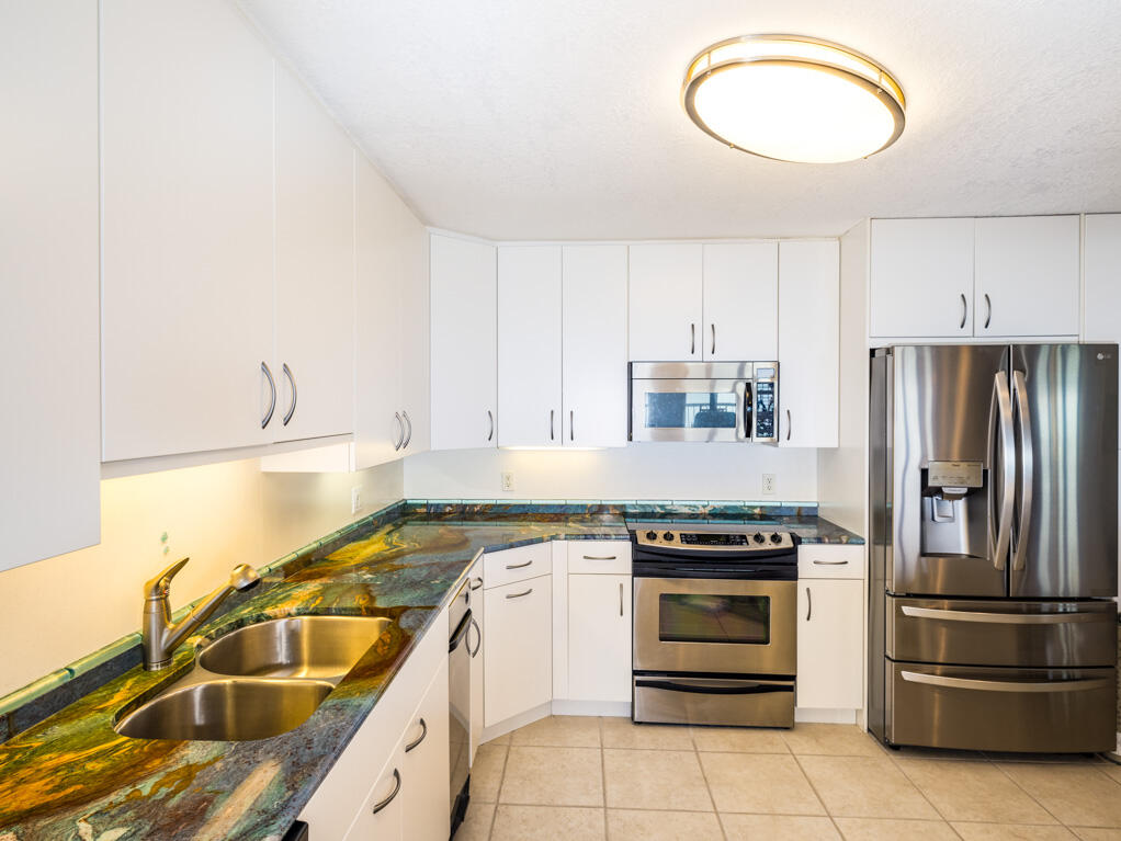 101 East Ocean Drive, Unit C304 Key Colony Beach, FL 33051 - Photo 11 of 39 a kitchen with a sink stove and refrigerator