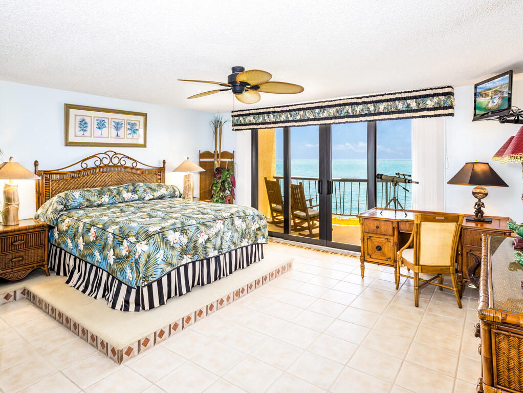 101 East Ocean Drive, Unit C304 Key Colony Beach, FL 33051 - Photo 14 of 39 a bedroom with a bed and a large window