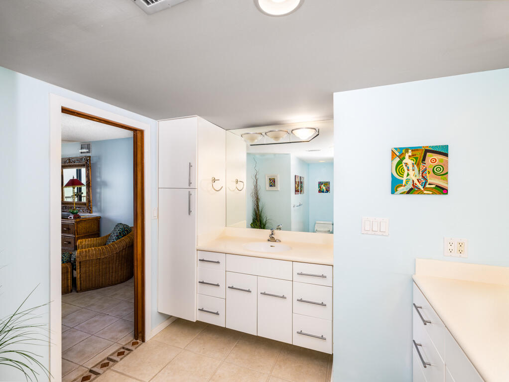 101 East Ocean Drive, Unit C304 Key Colony Beach, FL 33051 - Photo 17 of 39 a en suite bathroom with a sink a mirror and a shower