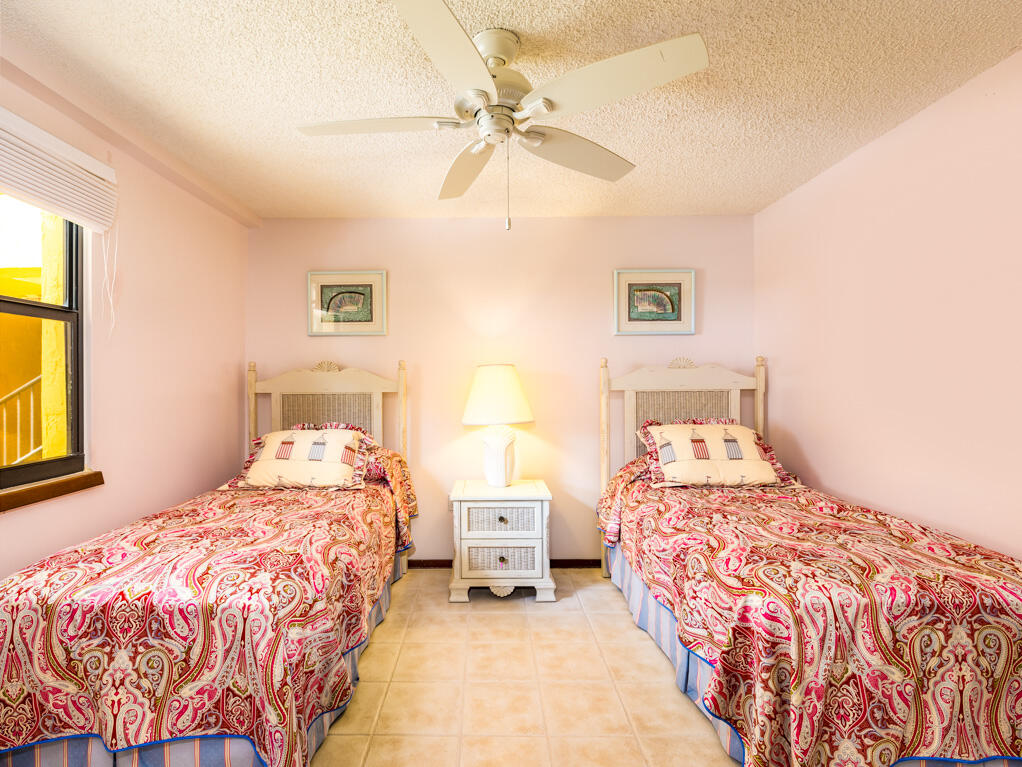 101 East Ocean Drive, Unit C304 Key Colony Beach, FL 33051 - Photo 18 of 39 a bedroom with a bed and a chandelier