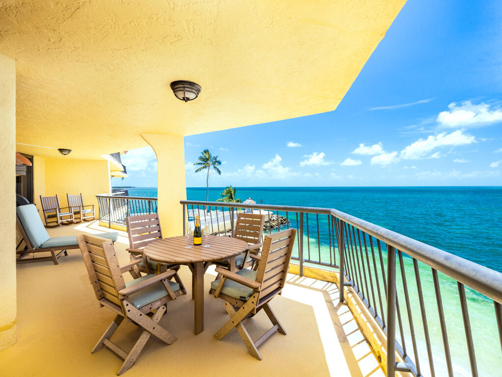 101 East Ocean Drive, Unit C304 Key Colony Beach, FL 33051 - Photo 4 of 39 a view of a balcony with furniture and floor to ceiling window