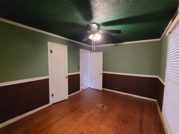 a view of empty room with fan and window