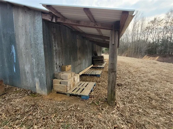 a view of a wooden house with a yard
