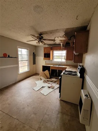 a room with furniture a flat screen tv and a window