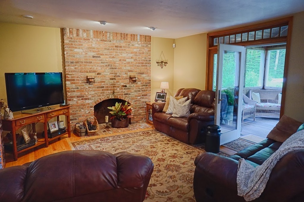93 Crawford Road Rutland, MA 01543 - Photo 6 of 30 a living room with furniture a flat screen tv and a fireplace