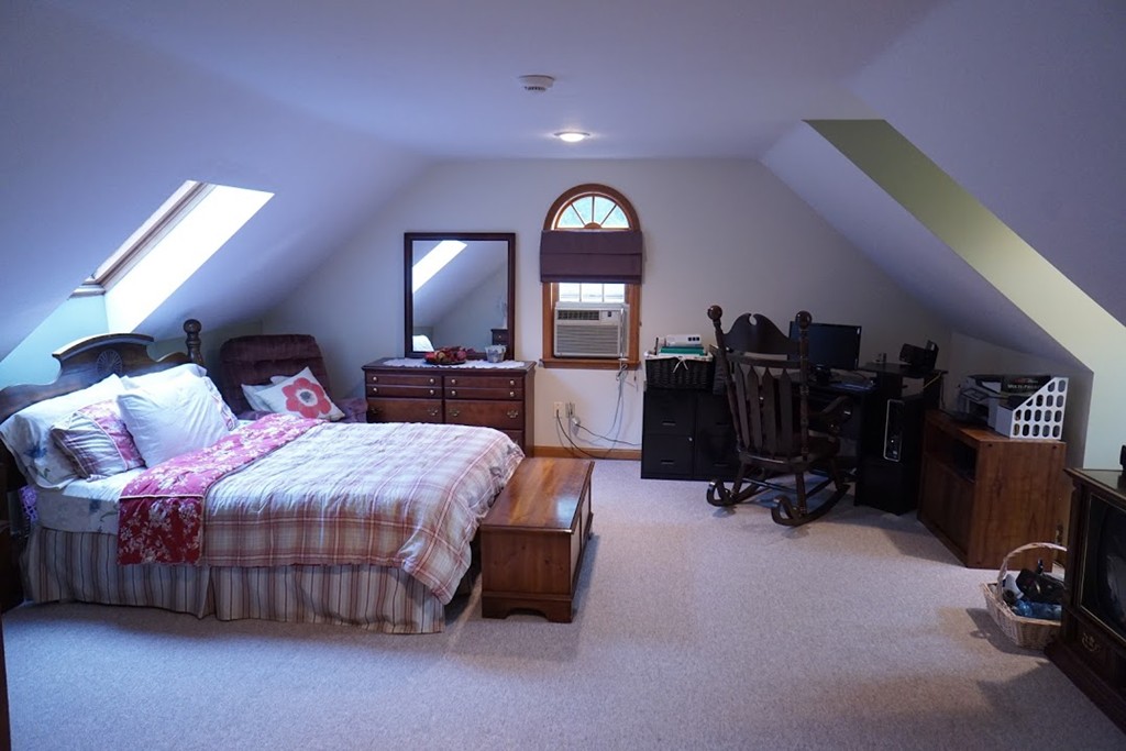 93 Crawford Road Rutland, MA 01543 - Photo 10 of 30 a bedroom with a bed a dresser and gym equipment