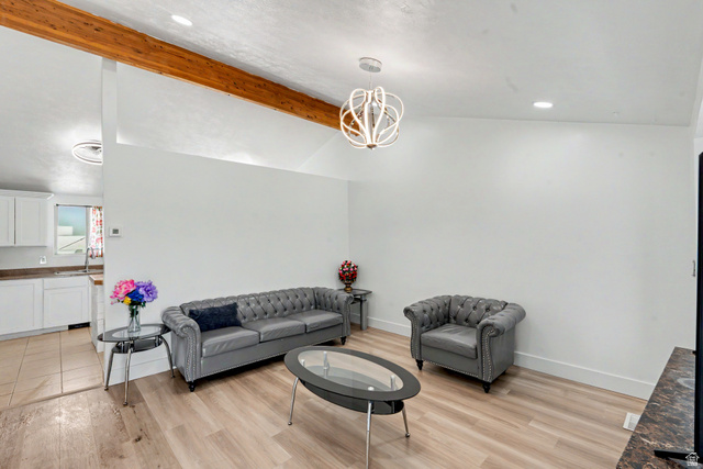 3689 Lasso Loop Circle Magna, UT 84044 - Photo 4 of 26 Vaulted ceiling featuring a prominent exposed wood beam and a contemporary chandelier