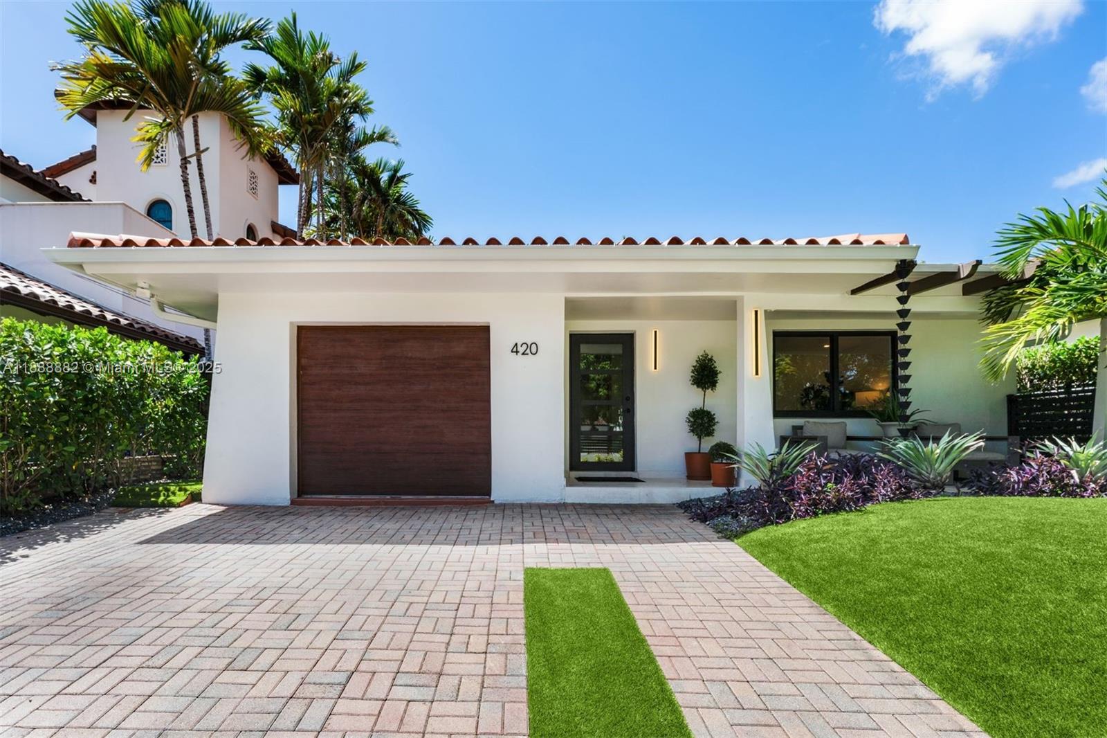 420 Southwest 19th Road Miami, FL 33129 - Photo 1 of 32 a view of a house with garden and a porch