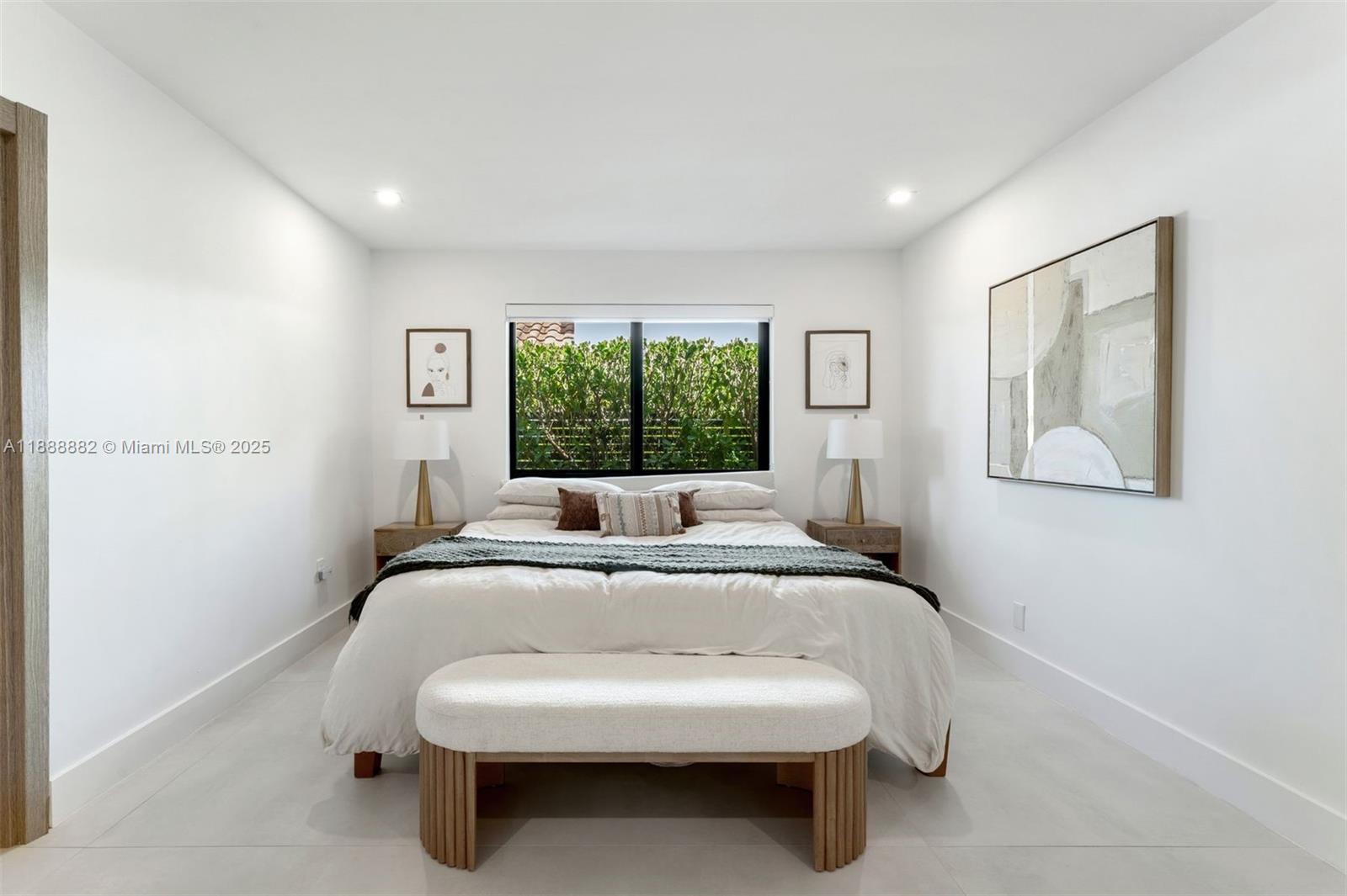 420 Southwest 19th Road Miami, FL 33129 - Photo 12 of 32 a bed sitting in a spacious bedroom next to a window