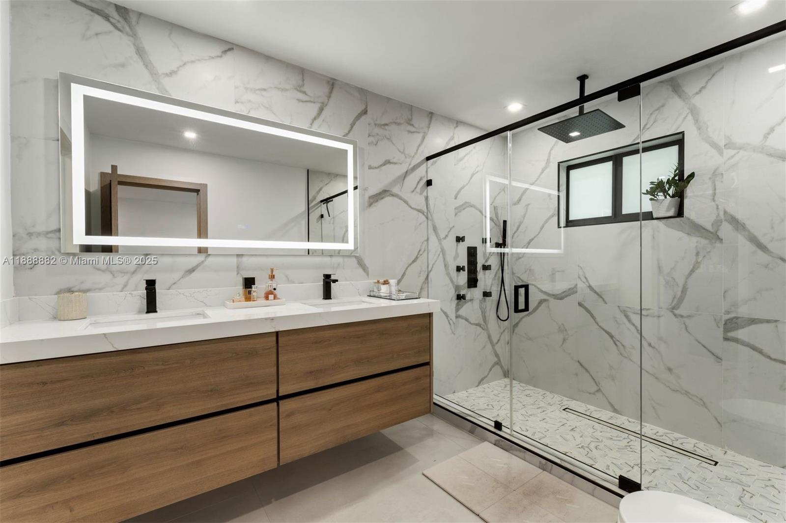 420 Southwest 19th Road Miami, FL 33129 - Photo 14 of 32 a bathroom with a double vanity sink mirror and shower