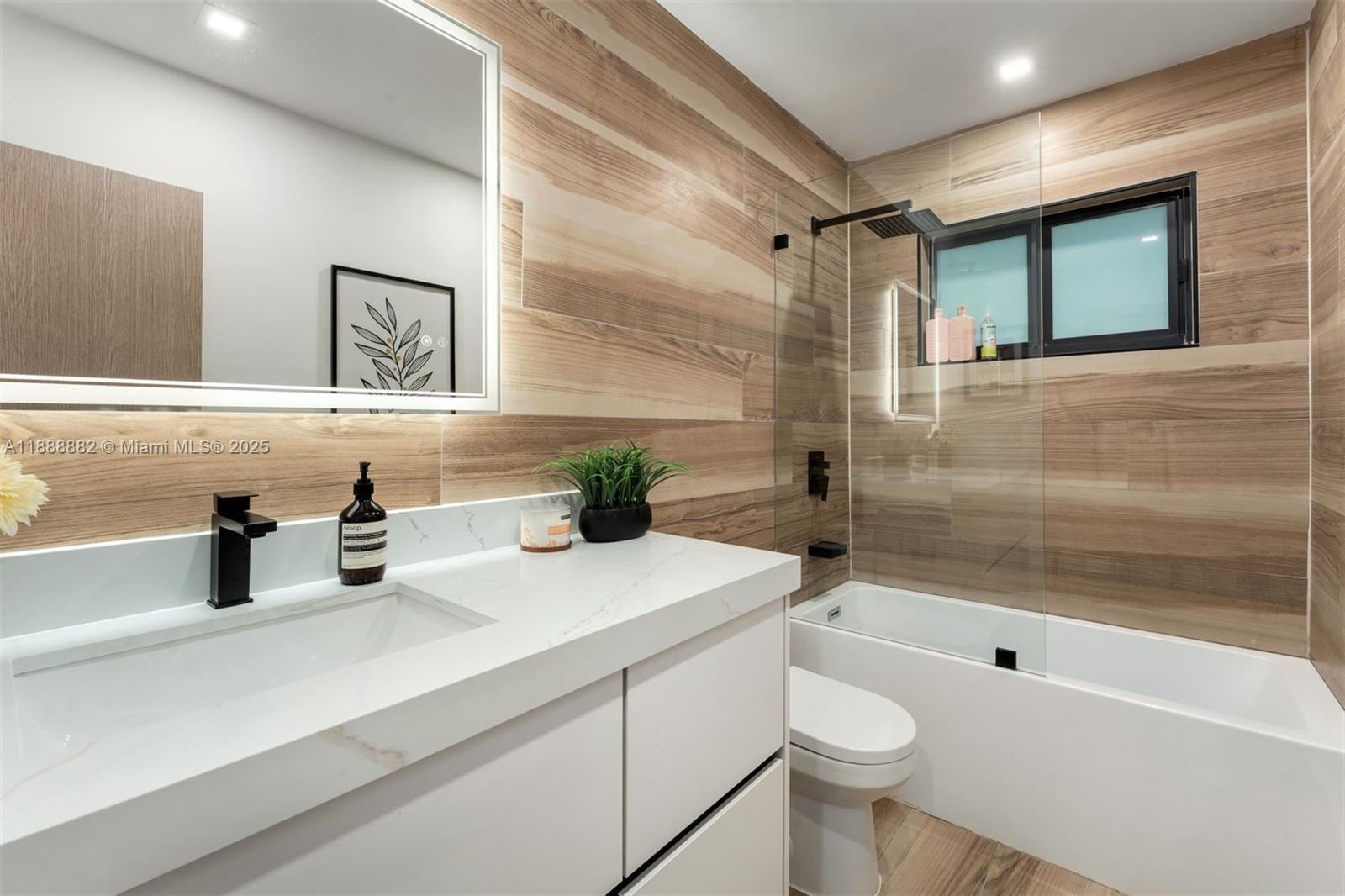 420 Southwest 19th Road Miami, FL 33129 - Photo 18 of 32 a bathroom with a sink a toilet and shower