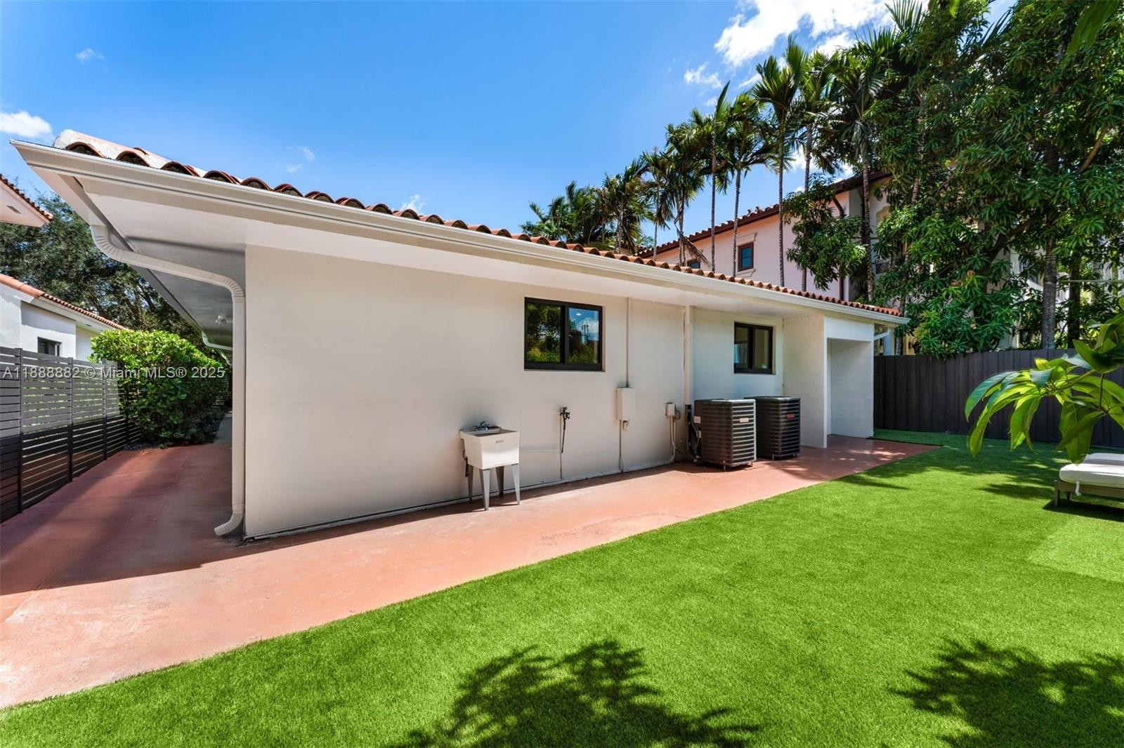 420 Southwest 19th Road Miami, FL 33129 - Photo 26 of 32 a view of a patio with table and chairs potted plants and large tree