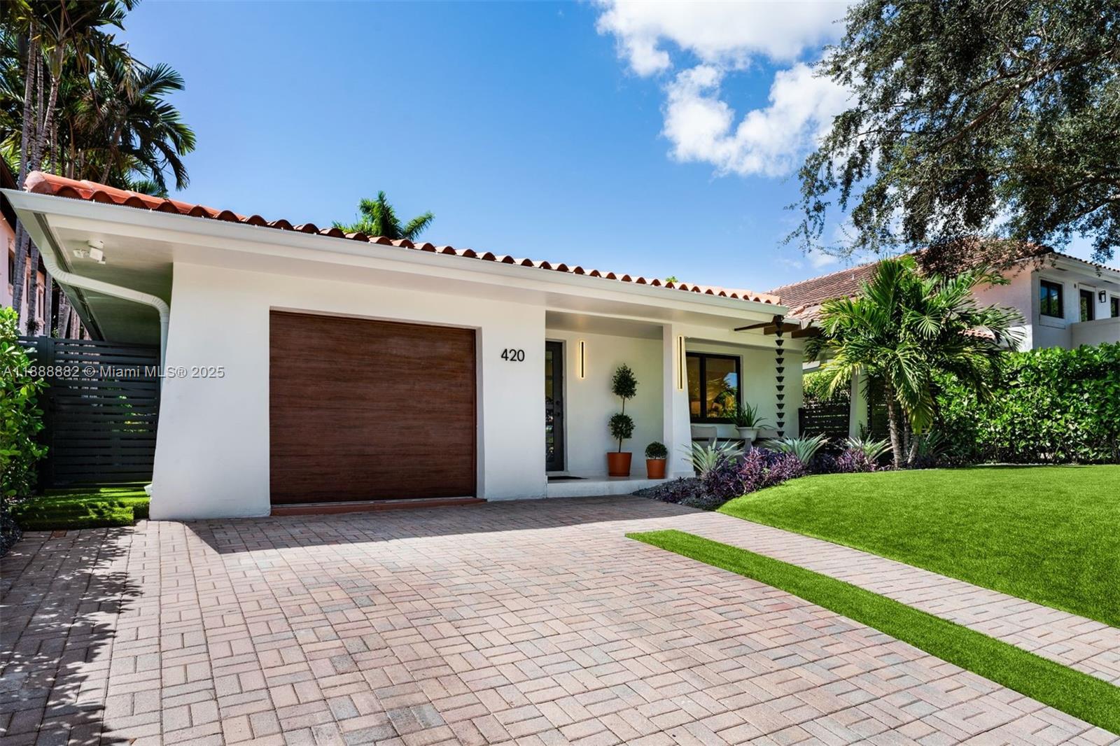 420 Southwest 19th Road Miami, FL 33129 - Photo 27 of 32 a front view of a house with a yard and garage