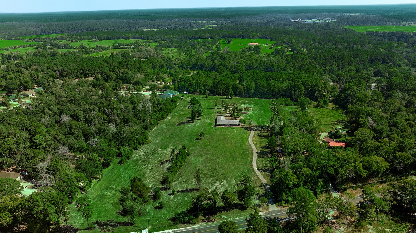 7185 Highway 75 Huntsville, TX 77340 - Photo 32 of 33 a view of a green field with lots of bushes