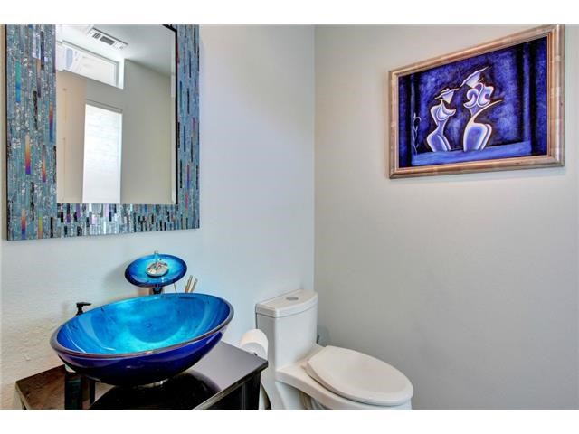 2918 Ranch Road 620, Unit K170 Austin, TX 78734 - Photo 10 of 22 A vibrant blue glass vessel sink creates a striking focal point in this powder room.