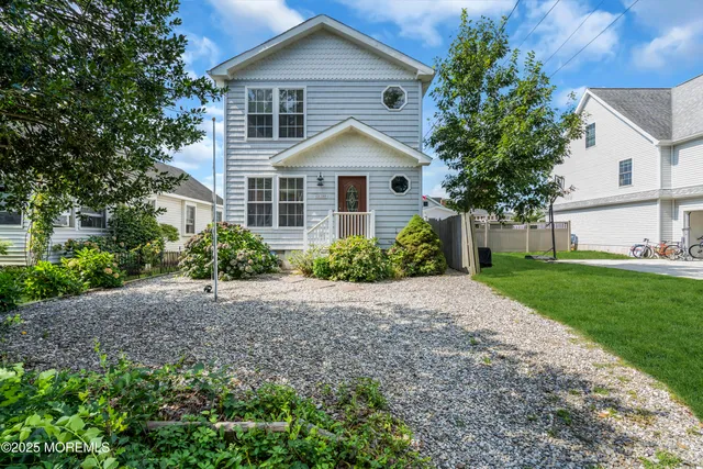 a view of a house with yard and a garden