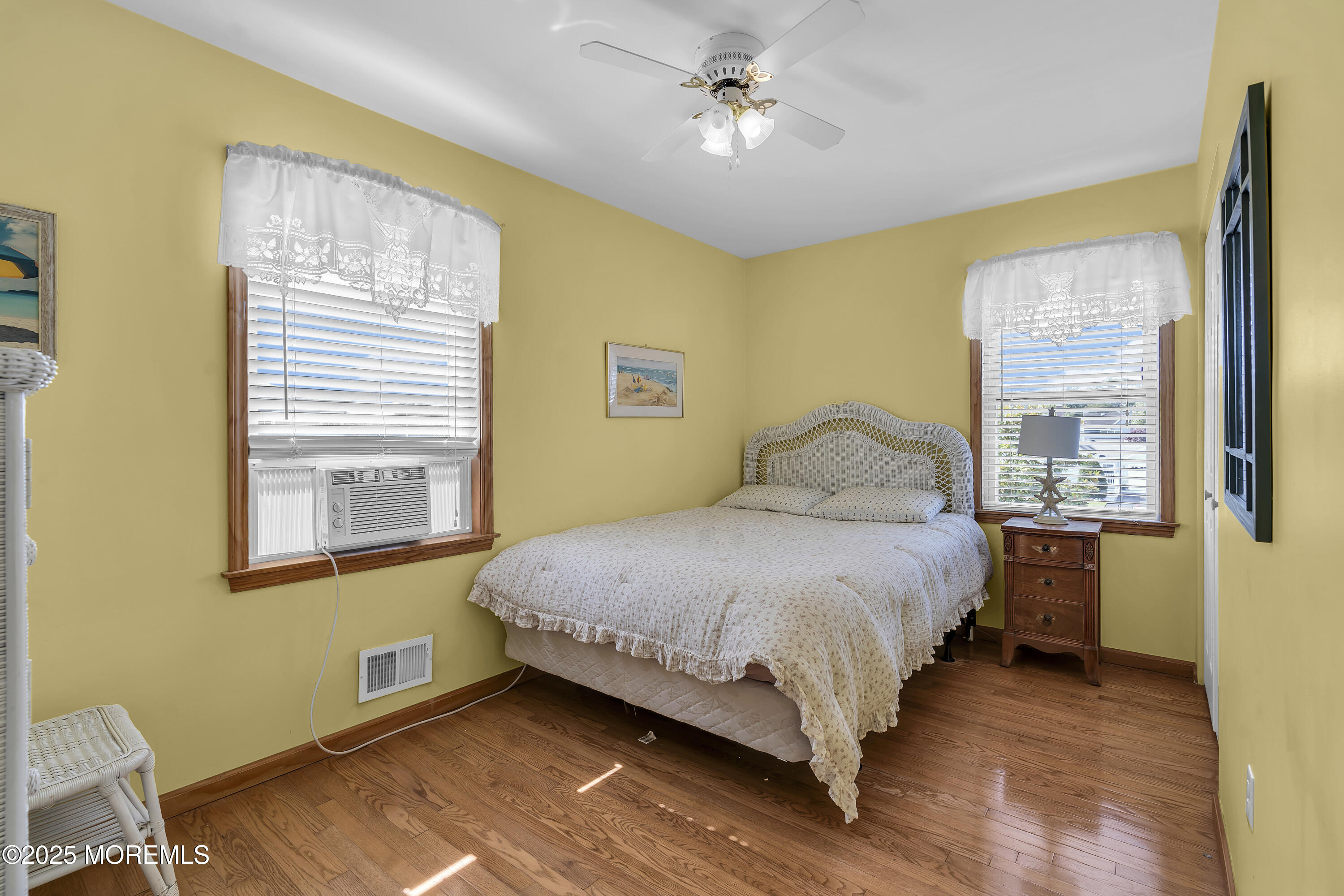 143 Lake Avenue Manasquan, NJ 08736 - Photo 11 of 18 a bedroom with a bed wooden floor and a window