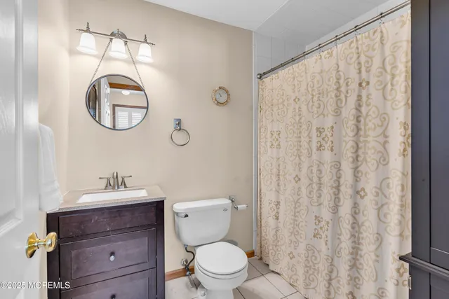 a bathroom with a toilet a sink and a mirror