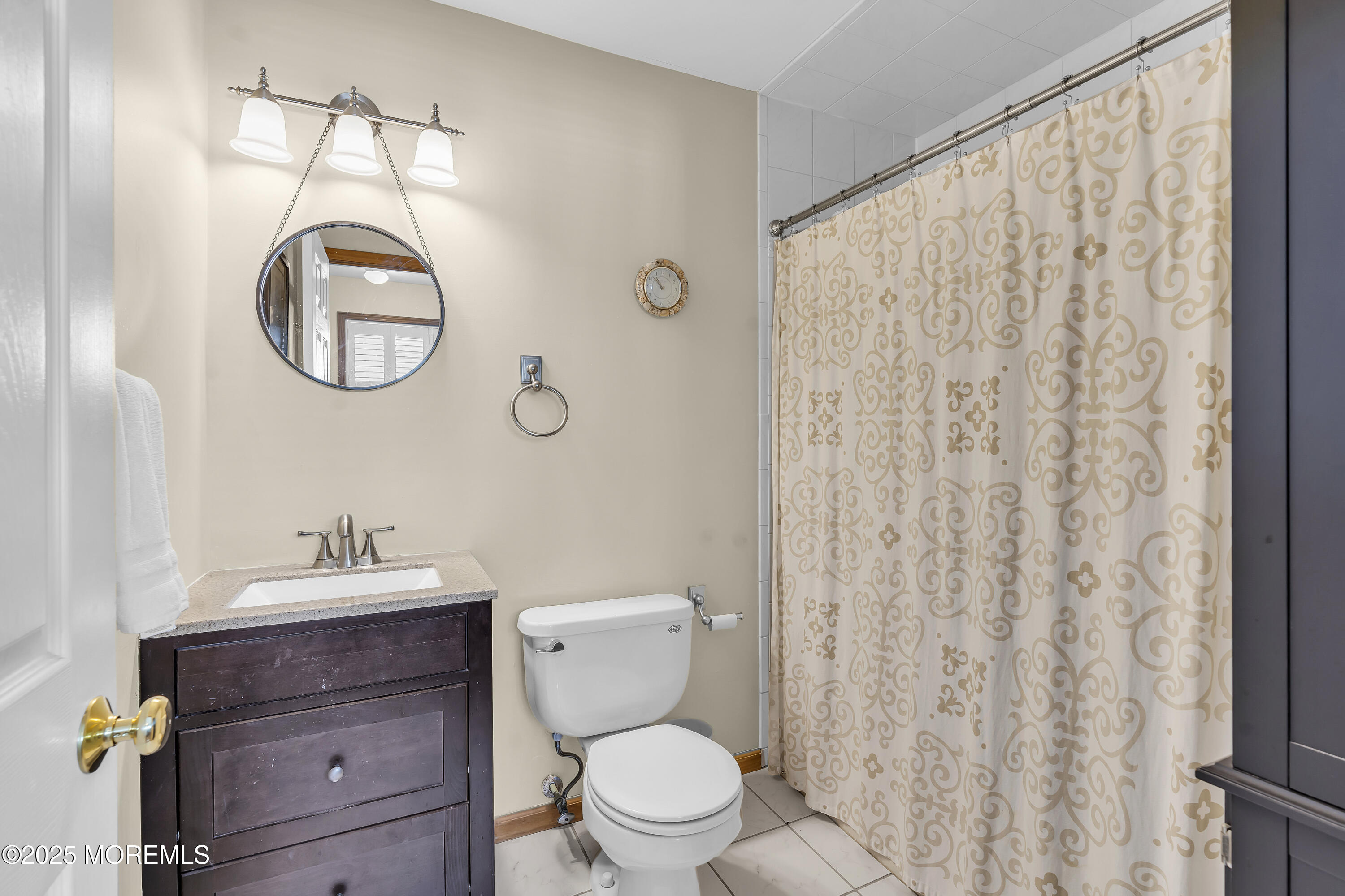 143 Lake Avenue Manasquan, NJ 08736 - Photo 13 of 18 a bathroom with a toilet a sink and a mirror