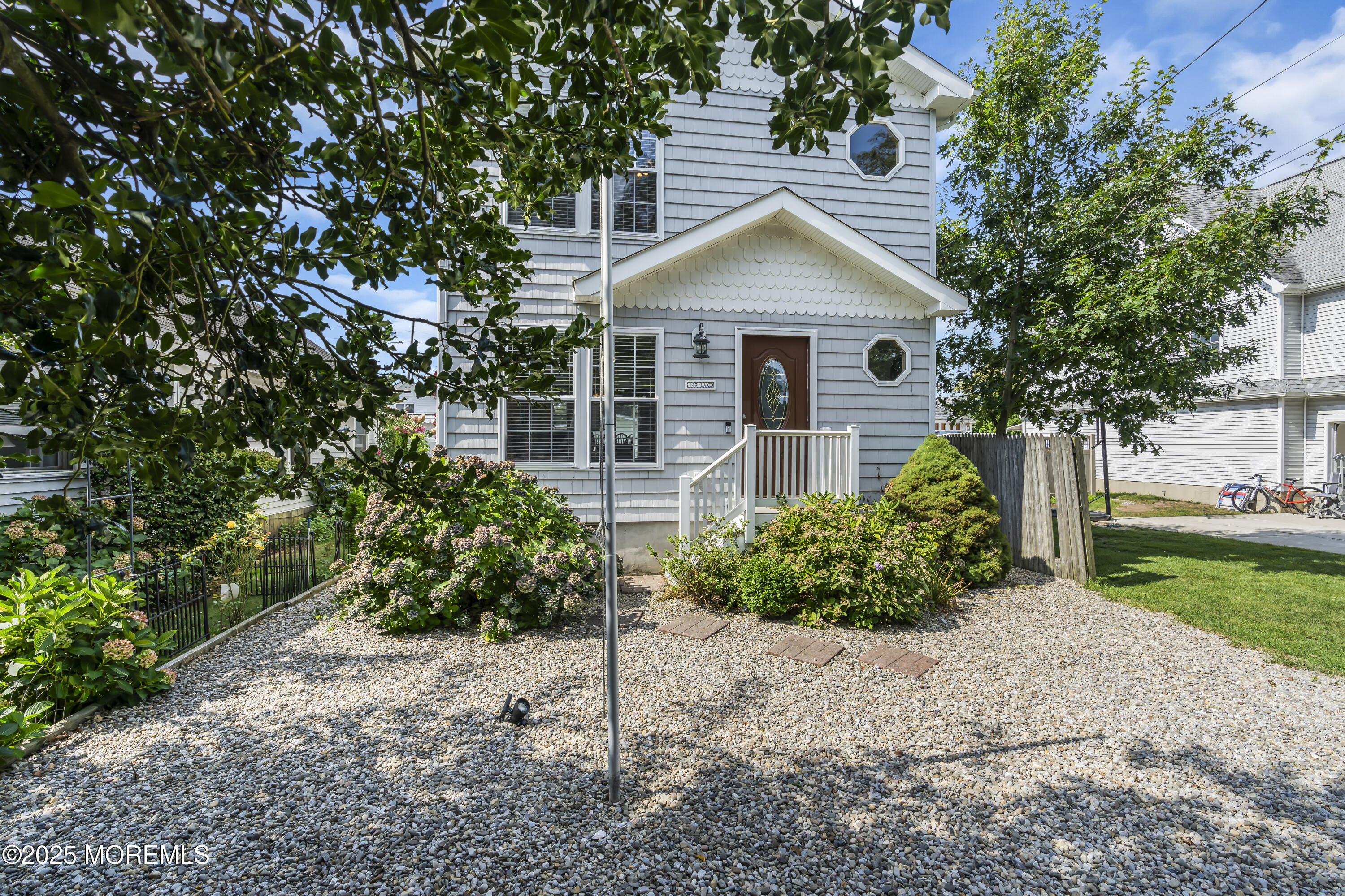 143 Lake Avenue Manasquan, NJ 08736 - Photo 17 of 18 a front view of a house with garden