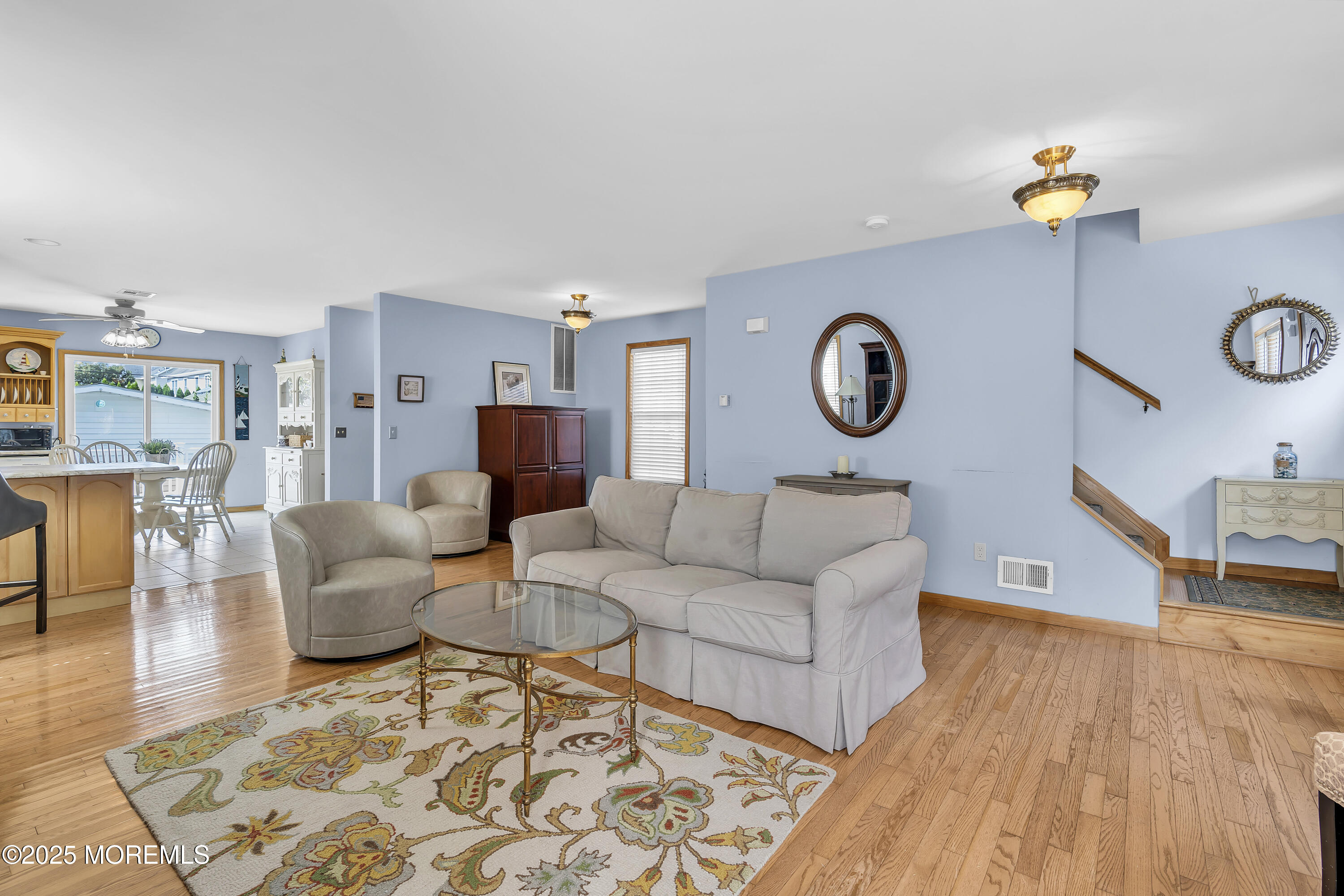 143 Lake Avenue Manasquan, NJ 08736 - Photo 3 of 18 a living room with furniture a clock on wall and a table